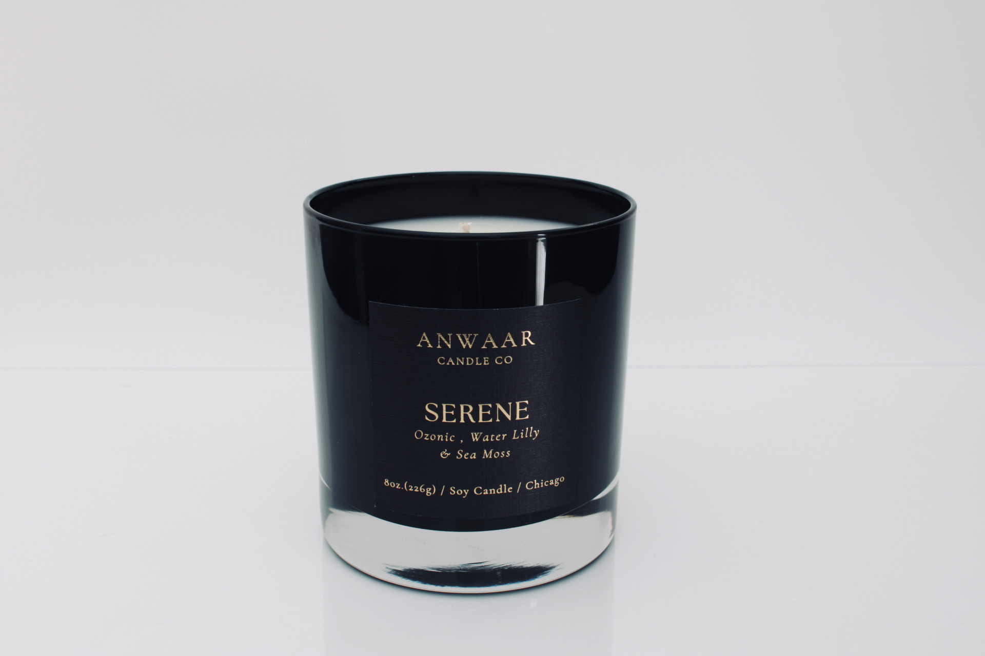 Serene - black elegant candle vessel with black label and gold letters with details about the product 