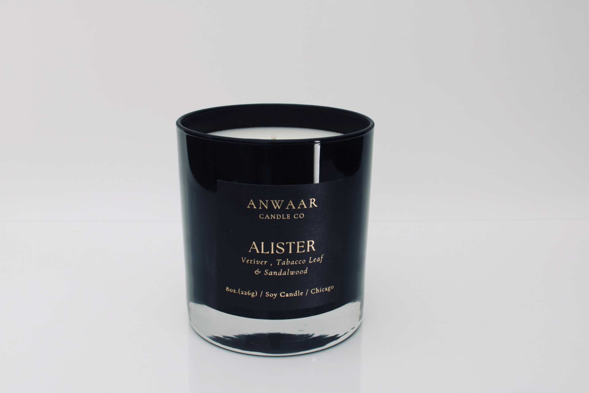 Alistr- luxury black glass vessel with black label, gold letters with details about the product