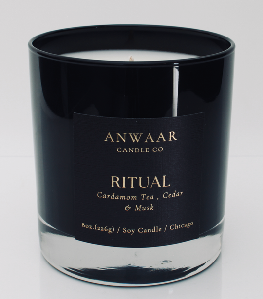 Ritual - black elegant candle vessel with black label and gold letters with details about the product  